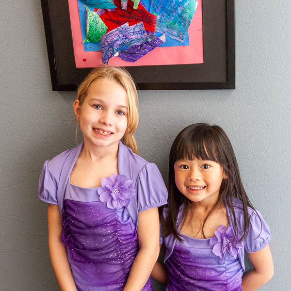 Young students in front of their artwork