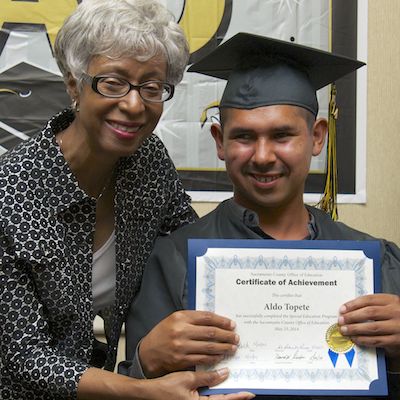 Thomaysa M. Glover presenting certificate to graduate