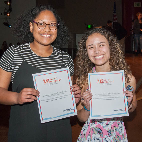 Students holding up certificates