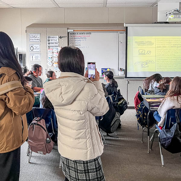 Teachers taking pictures in a classroom