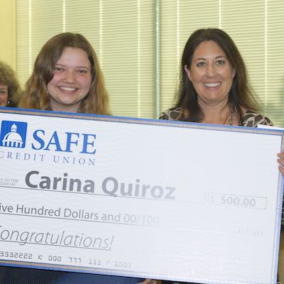 Student receiving large ceremonial check from SAFE Credit Union