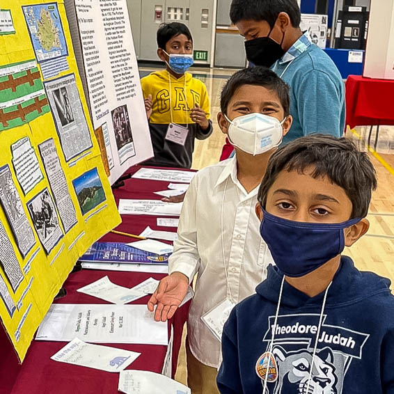 Students posing in front of project