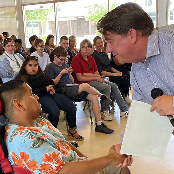 Student shaking hands and receiving a certificate