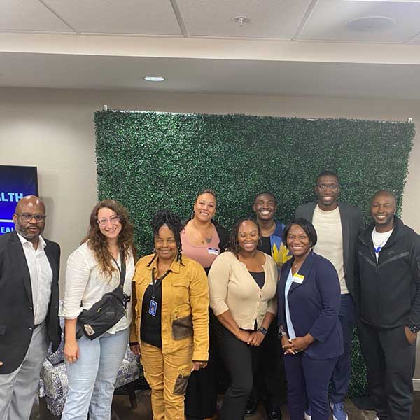 Group of attendees posing with Tabitha Thompson