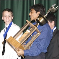 Student hoding large trophy