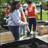 Students shoveling dirt in planters