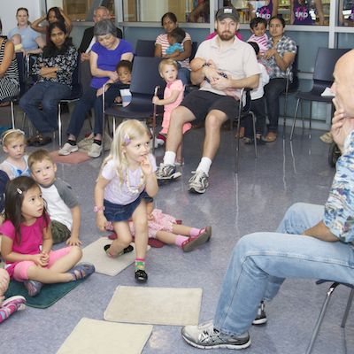 Kings representative reading to young children