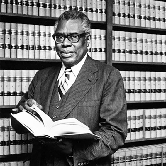 Nathaniel S. Colley standing in front of law books