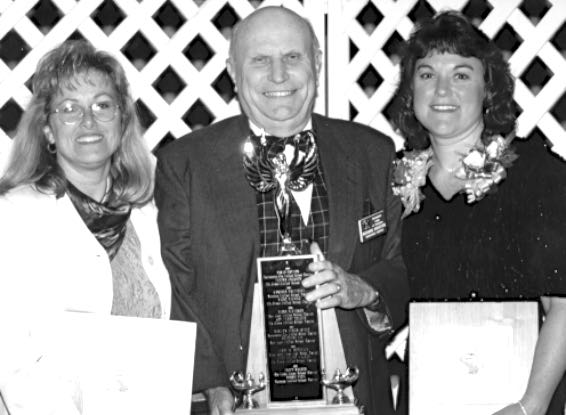 Scottish Rite representative presenting large trophy with engraved names