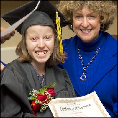 Board member presenting certificate of achievement to student