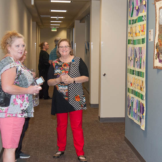 Employees admiring hanging artwork