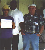 Instructor with student holding certificate