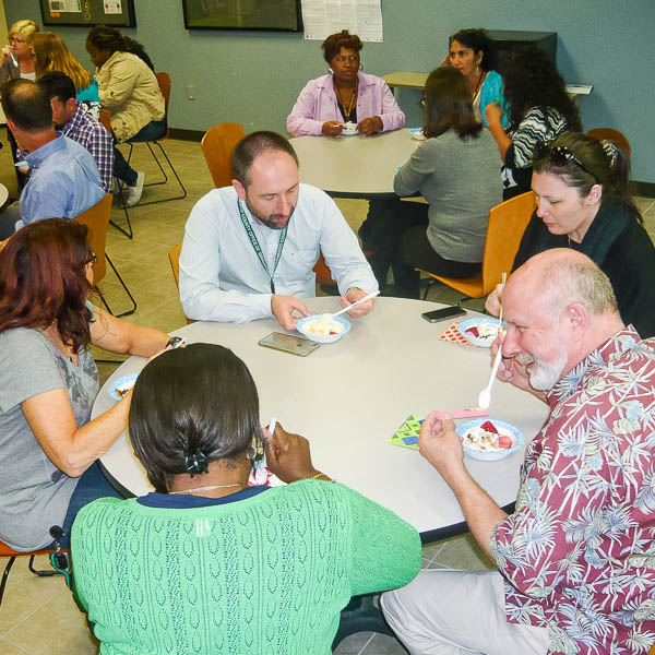 Staff sitting at tables eating ice cream