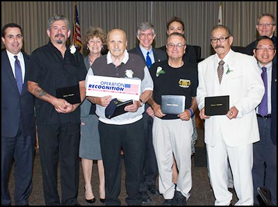 Operation Recognition diploma recipients holding sign