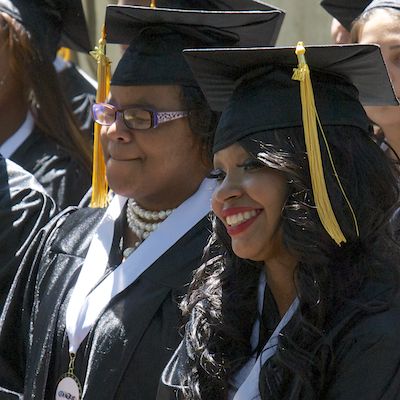 Smiling students wearing caps and gowns