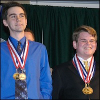 Students smiling as they receive medals