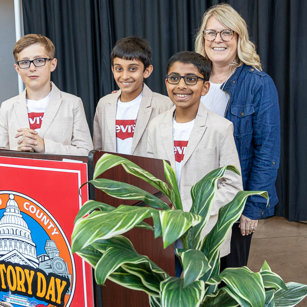 Students posing at lectern