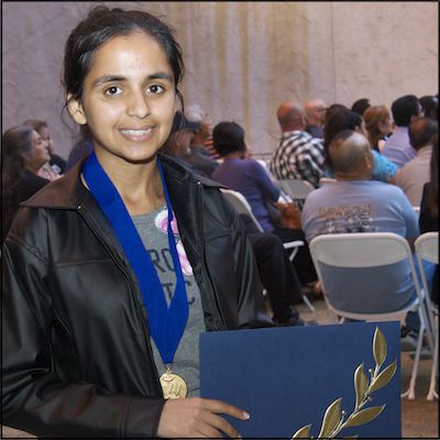 Student holding certificate