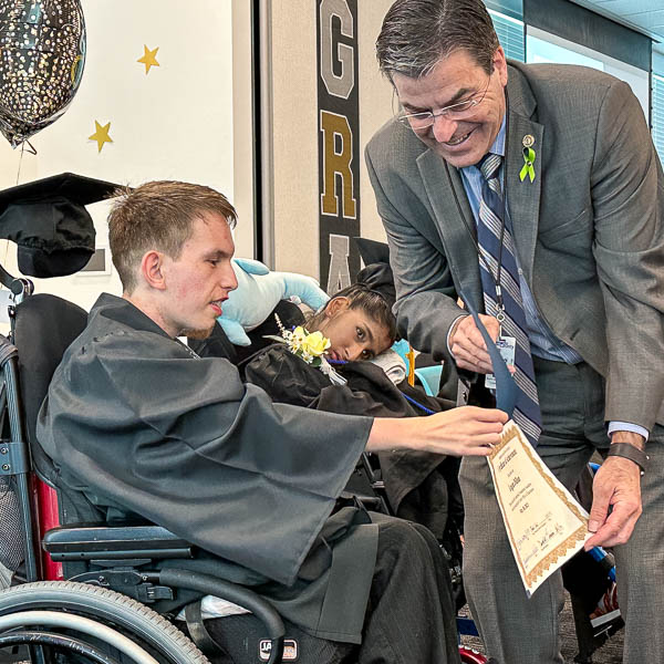 Paul Keefer presenting certificate to a student