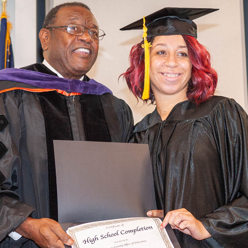 Graduate receiving certificate from Board trustee