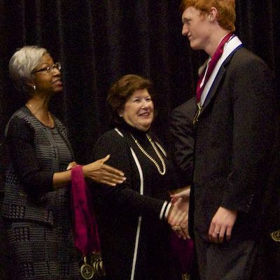 Board members presenting medals to students