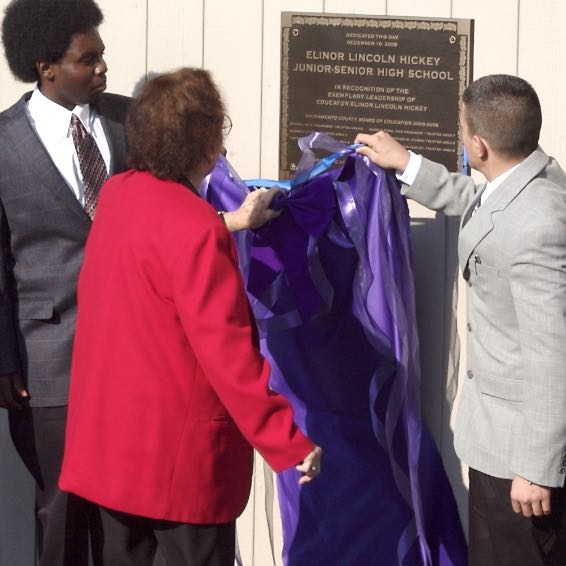 Unveiling of the plaque, covered by a purple cloth and ribbon