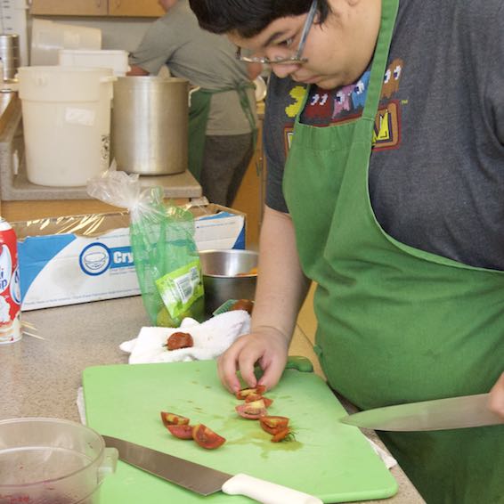 Student cutting tomatoes