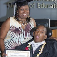 Smiling parent holding certificate with student