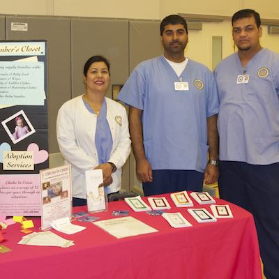 Representatives standing at booth with flyers