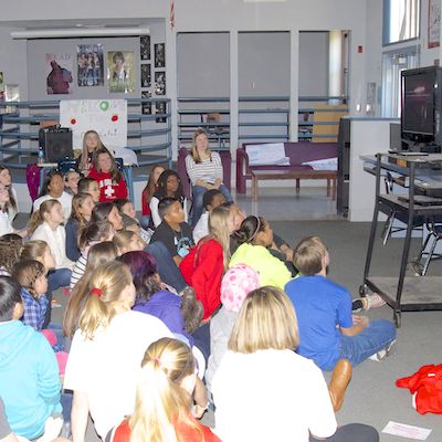 Students watching video on TV screen