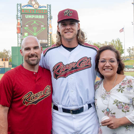 Scott Burton and Laura Walker posing with River Cats catcher