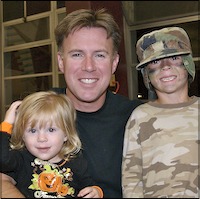 Children dressed in costume pose with father