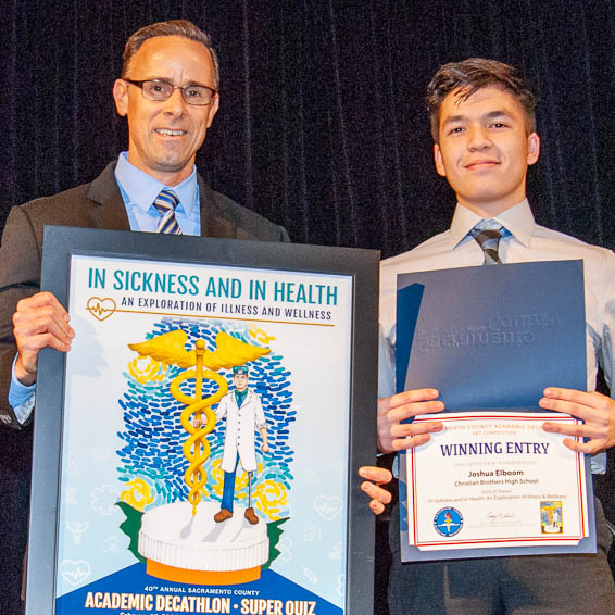 Student receiving framed poster and certificate