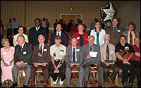 Diploma recipients sitting with Board of Education trustees