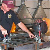 Teacher helping student weld