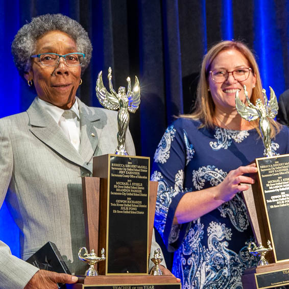 Gewon Richards and Julie Fong holding trophies