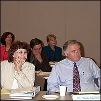 Audience members listening to the presentation