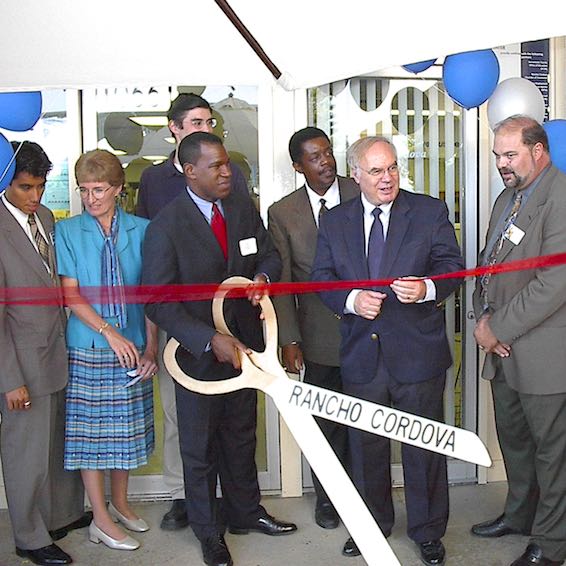 Dignitaries cutting ribbon with giant Rancho Cordova scissors