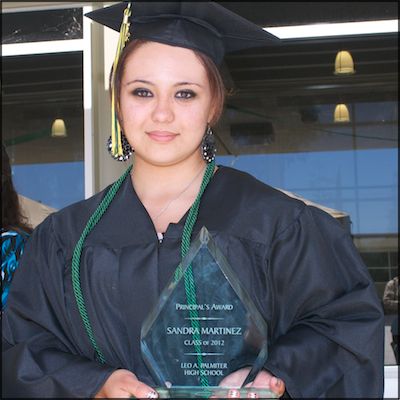 Graduate holding plaque