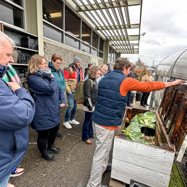 Visitors inspecting a compost bin