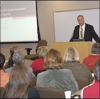 Marty Cavanaugh speaking at lectern