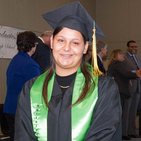 Graduate posing in cap and gown