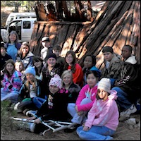Students in front of cedar bark house