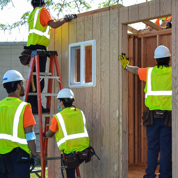 Construction students building a structure