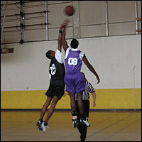 Players jump for the basketball