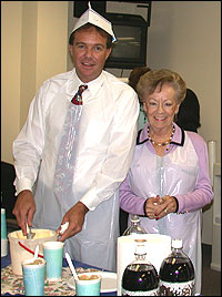 Cabinet members in aprons and hats, making ice cream floats