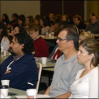 Seated audience listening to presentation