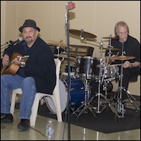 Guitarist and drummer performing