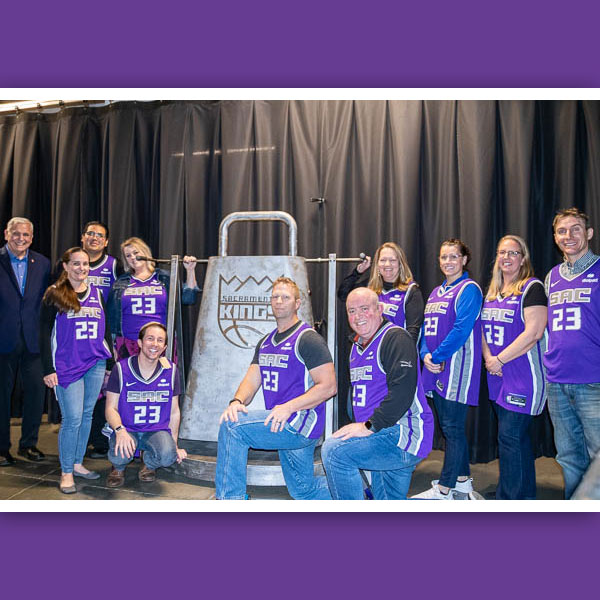 Teachers posing with Kings cow bell