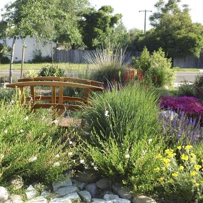 Landscaping around decorative walkway bridge